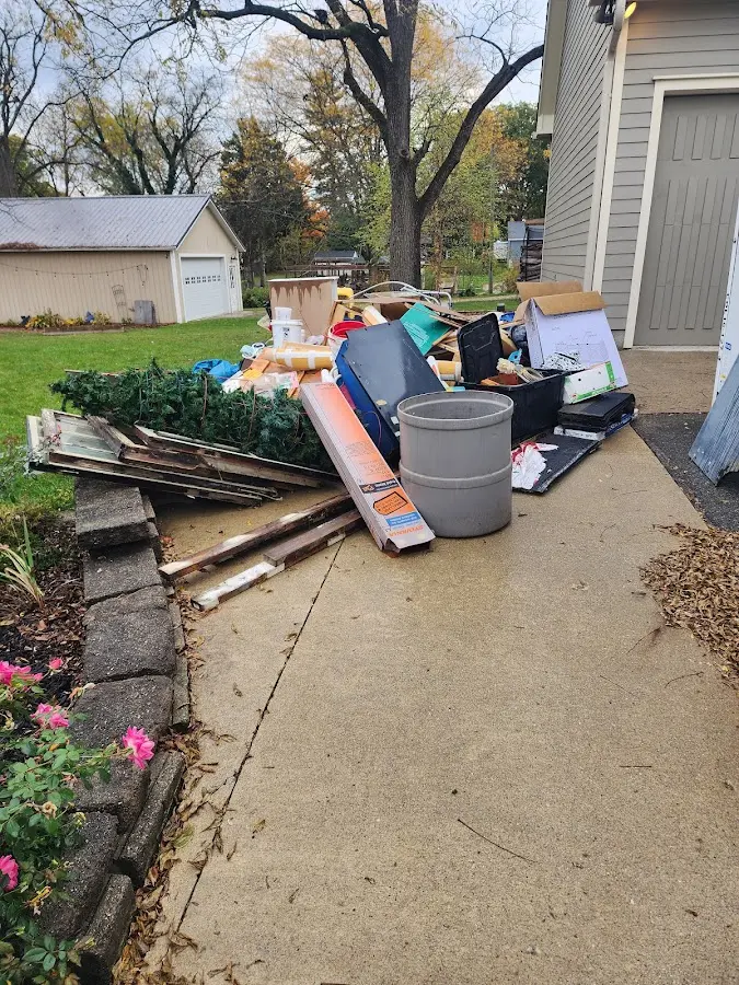 Dumpster being loaded with debris for 12 Yard Dumpster Rental in Dewey